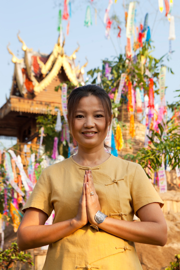 Northern Thai Lady with traditional Wai greeting.